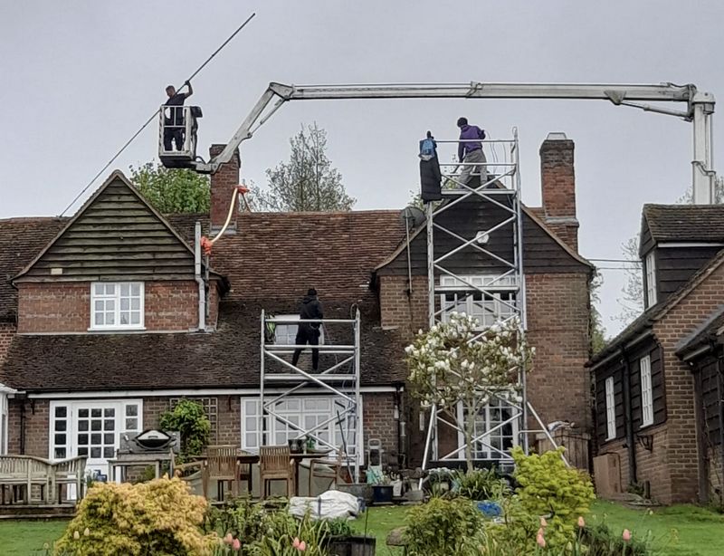 The Moss Cleaners using cherry picker and scaffolding to clean roof safely and professionally in Long Lawford, Warwickshire